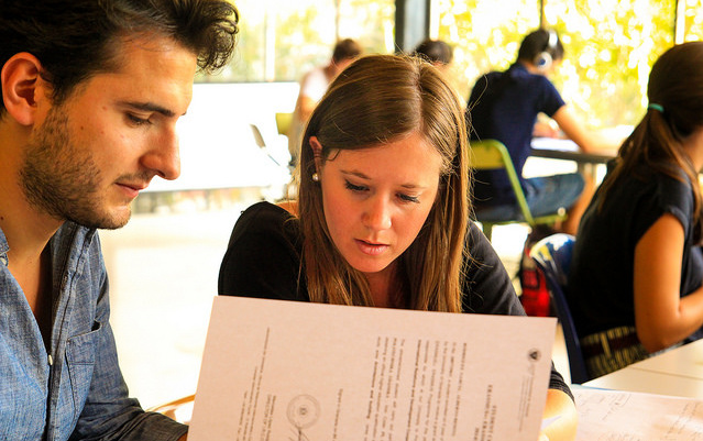 Two students looking at paperwork