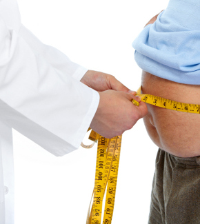 A doctor measuring a man's waistline