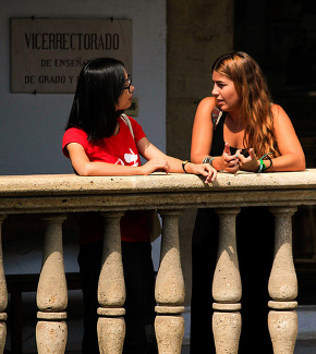 Two students chatting outside a university building