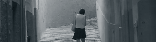 mujer de espaldas andando por una calle del caso antoguo de Mallorca