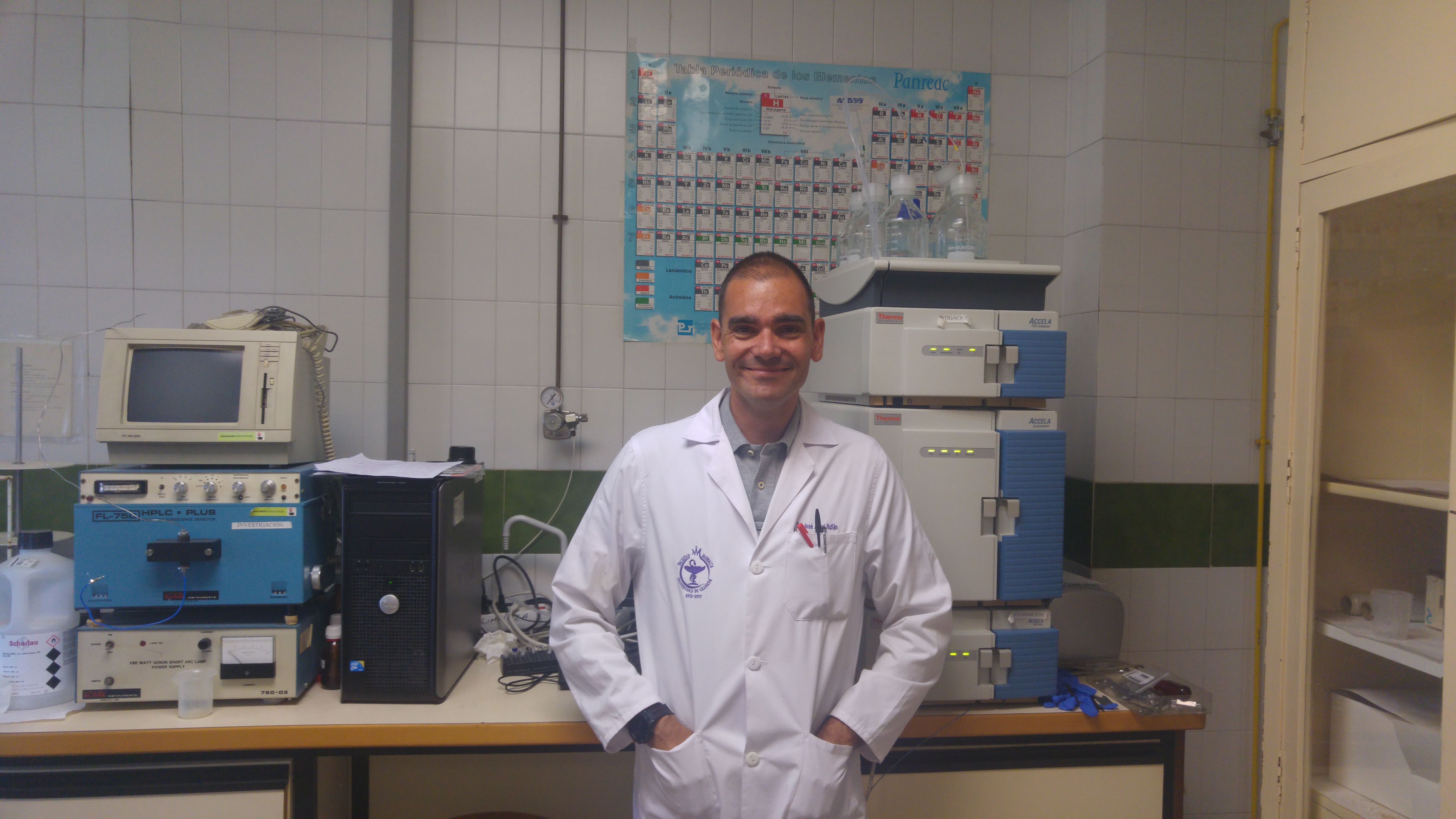 A researcher in a lab, smiling.