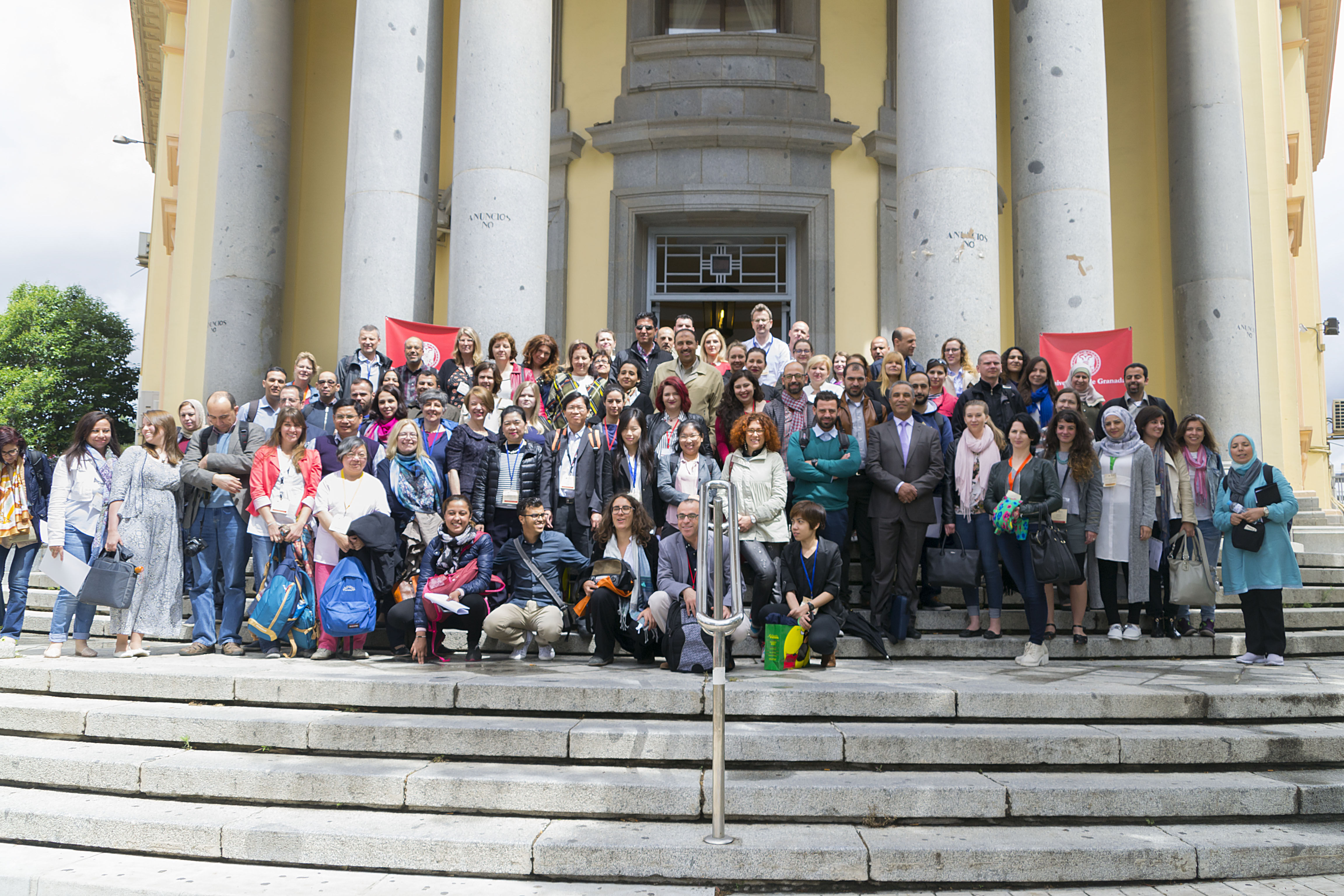 Over 70 participants posing for a photo in front of the former Faculty of Medicine