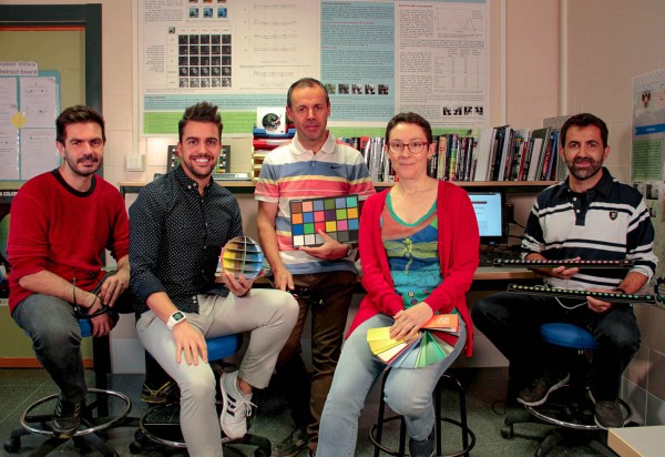 Five researchers in a laboratory holding colour wheels and charts