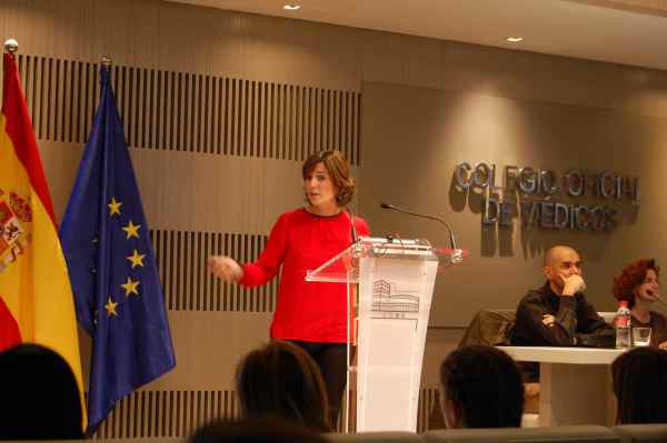 A woman delivering a presentation at a conference