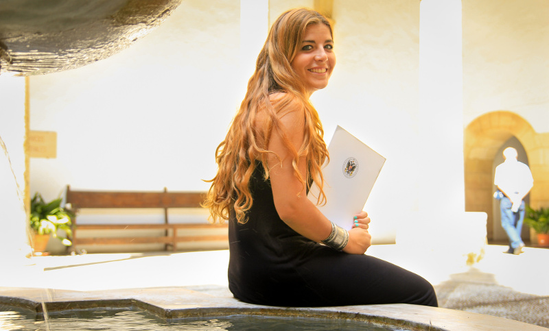 A student sitting beside a fountain 