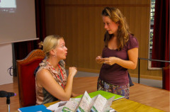 A staff member helping a student at a desk