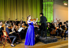 A student playing the violin at a concert