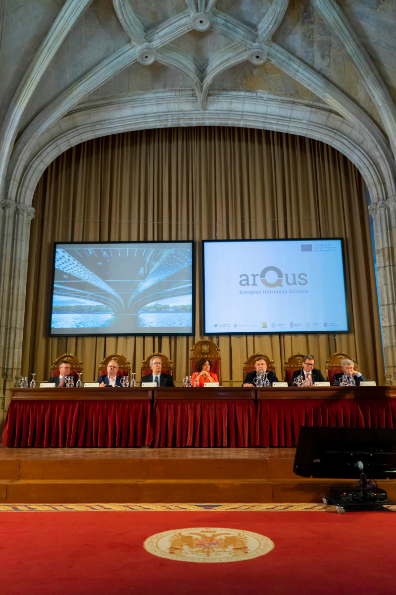 6 Arqus representatives sitting on a stage in the Hospital Real building