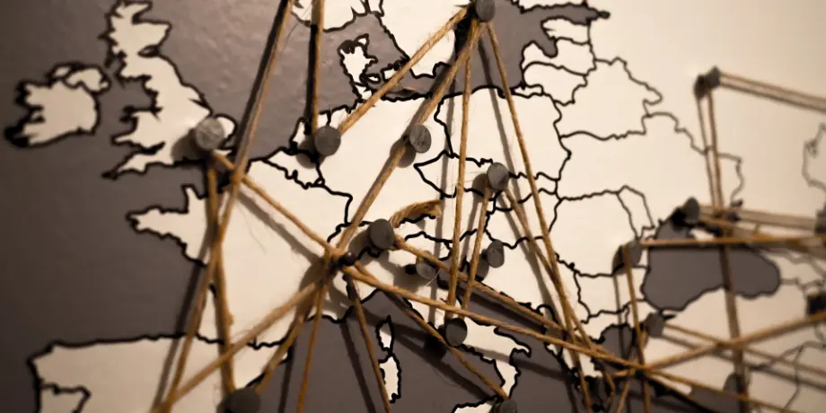 Map of Europe with pins connected by threads