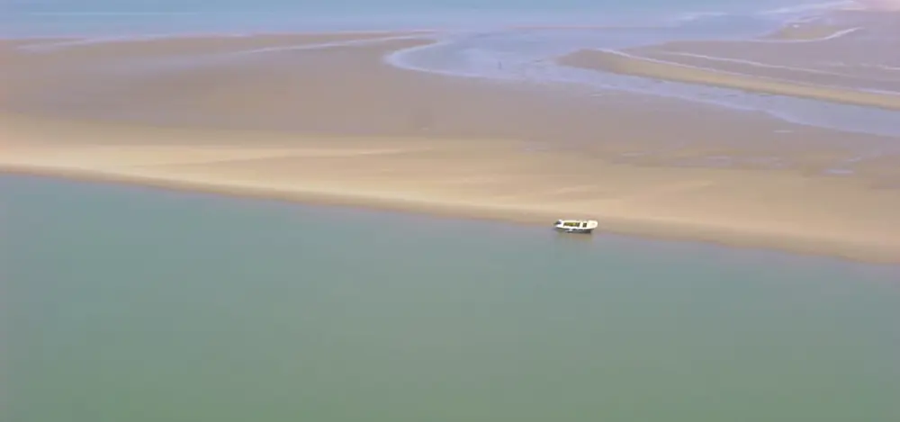 Aerial view of sandbanks and channels at a river mouth